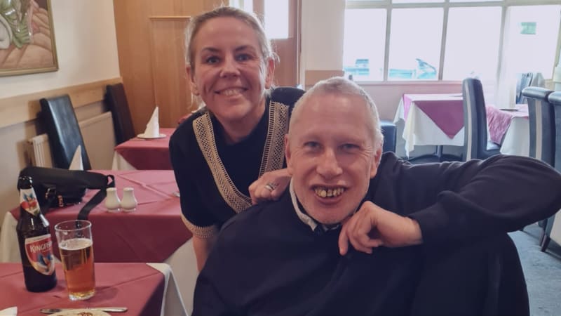 Dave with his support worker, Annmarie. Dave and Annmarie are at a restaurant that they visited on Dave